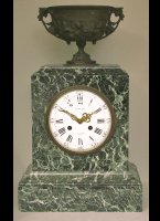 Green marble mantel clock with a bronze vase on top, signed 'Raingo Frres  Paris'.