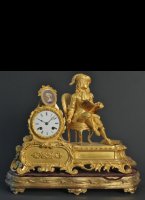 Firegilded bronze clock with detailed representation and Svre porcelan portret. Has gilded wooden basement.