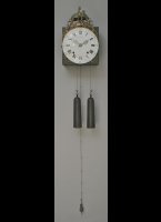 French wallclock with enamel dialplate, iron hands, long pendulum on the back of the movement. Casted top-ornament with the 2 hands as symbol of brotherhood (fraternit) in the french revolution.