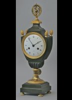 French vase clock. partly firegilded and patinated, armillery sphere on top, 8-day movement with silk suspension pendulum.