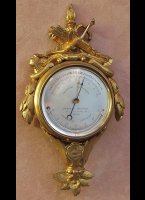 Gilded cartel with barometer and thermometer, silvered dialplate signed: 'Bunoust Ing-Opt, Palais-Royal 43, Paris'. Height 20 cm, ca. 1850-80.