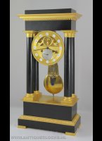 French column mantel clock with visible escapement, gridiron half-second knife-suspended pendulum, fire-gilded capitals, basements and dial plate. Dial plate with enamel cartouches and silvered date dial, signed 'Cleret'