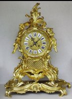 Bronze casted mantel clock in Louis XV style.