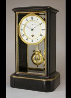 Black marble glass mantel clock by Achille Brocot with a year going movement and unusual temperature compensated pendulum (Ellicot style).
The movement has 5 serial connected barrels for the long duration. Full winding takes 80 half keyturns.

high: 49 cm
wide:  29 cm
deep:  22 cm
weight: 24 kg