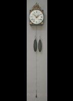 French wallclock with enamel concave and convex dialplate, iron hands, long pendulum on the back of the movement. Casted top-ornament with the Phrygian Cap or Liberty Cap as symbol of freedom in the french revolution.